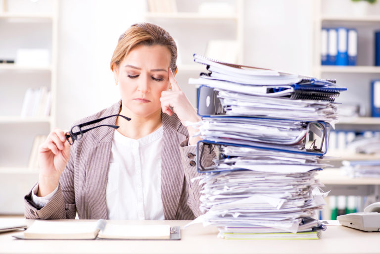 Businesswoman very busy with ongoing paperwork