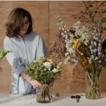 women taking care of flower at shop