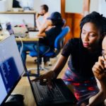 Woman discussing about business checking tech startup with her client