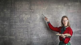 A Math tutor teaching on the board