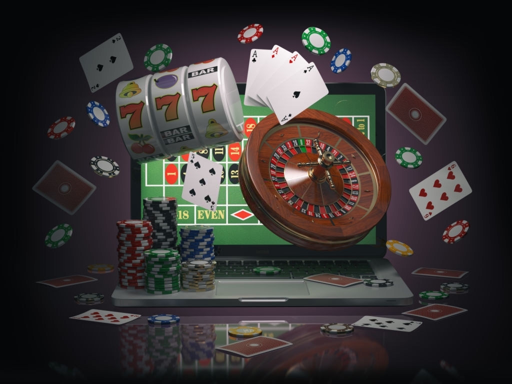 Online casino concept. Laptop with roulette, slot machine, casino chips and playing cards isolated on black background. 3d illustration