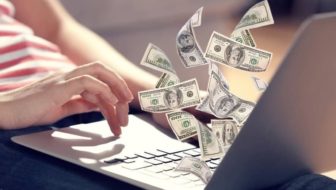 Man making money with cryptocurrency on his laptop.