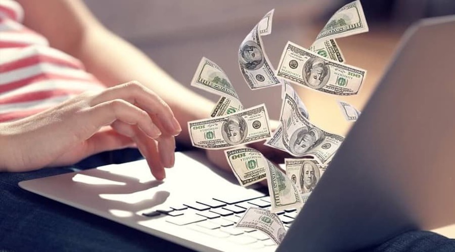 Man making money with cryptocurrency on his laptop.