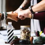 All the employees showing their loyalty by putting their fist forward.