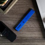 A blue vape pen placed on the table.