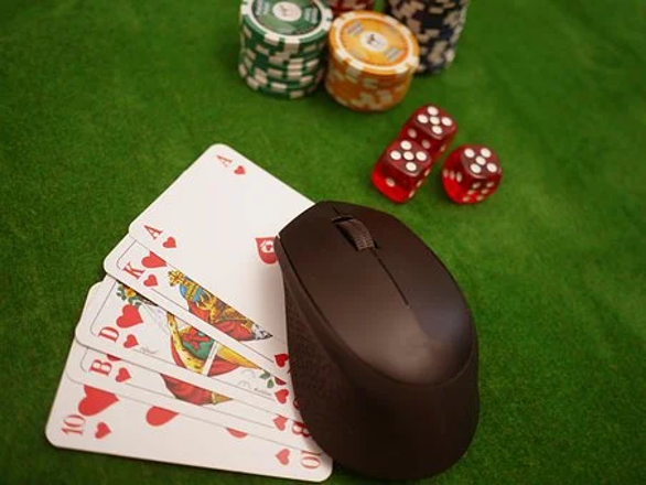 Poker game being played with cards,dice and coins.