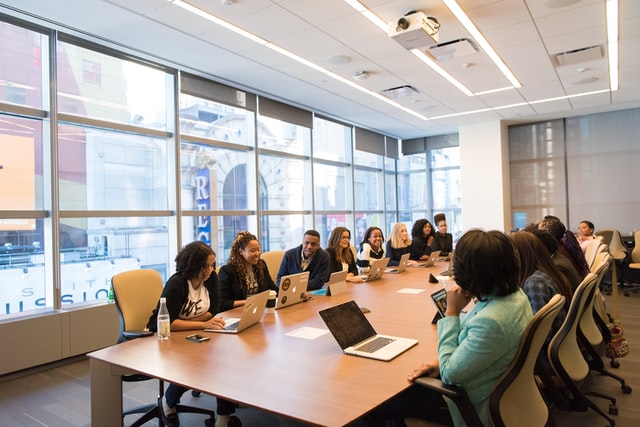 A team of members sitting in a board room.