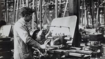 A labourer working with the machines in a factory