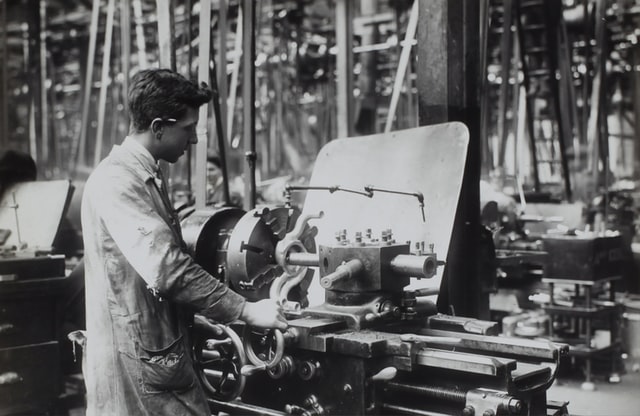A labourer working with the machines in a factory