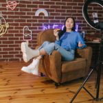 Woman recording a video of her own in a studio.