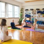 Women performing yoga in a fitness centre.