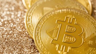 Golden Bitcoins placed on one another,