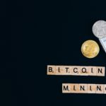 Bitcoin Mining and a smart phone with a bitcoin on it.
