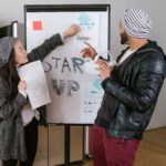 A man and woman talking about a startup company.
