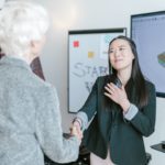 Woman shaking hands with an investor for her business.