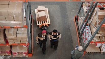 Two employees discussing about warehouse inventory.