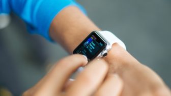A student checking out some stuff on her smart watch.