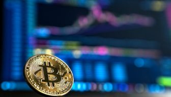 A golden bitcoin with letter B engraved on it.