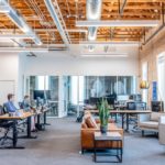 An office with employees working on desktops.