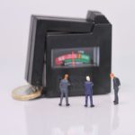 Three men checking the interest rate machine.