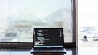 A laptop displaying programming language.