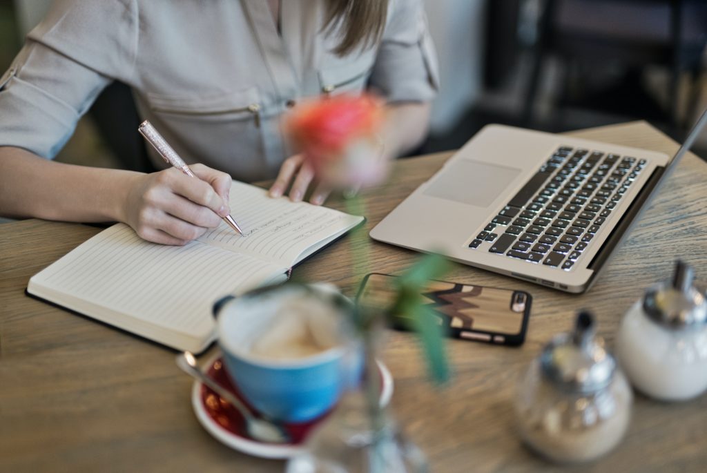 A woman writing an essay in her diary.