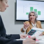 A woman helping the other woman in business operations.