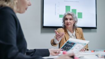A woman helping the other woman in business operations.