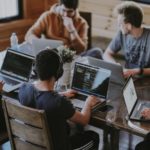 A group of employees working together on the systems.