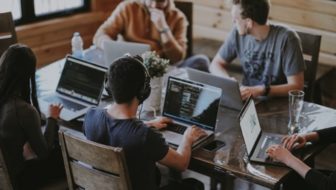 A group of employees working together on the systems.
