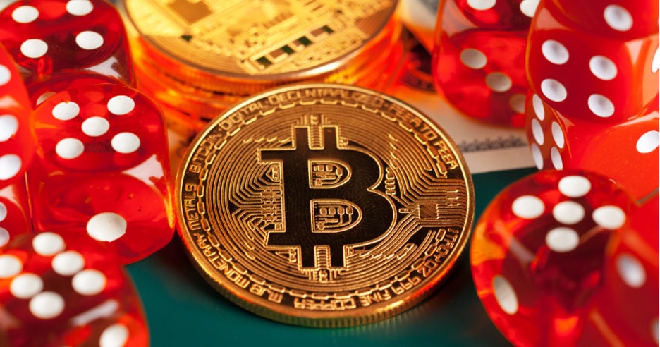 A golden bitcoin and red dice.