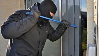 A burglar trying to open the gate.