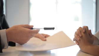 A man signing up the docs for a loan.