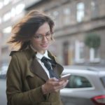 A woman looking into the mobile.