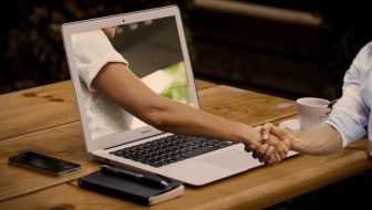 A man shaking hands for Online Business.