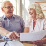 A senior citizen looking into loan papers.