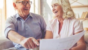 A senior citizen looking into loan papers.