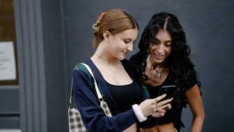 Two women looking in the phone.