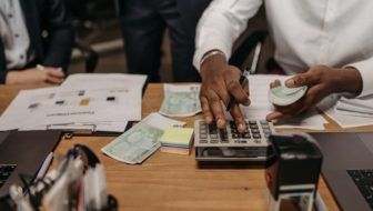 A man calculating and collecting cash.