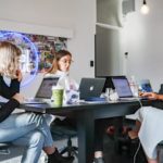 3 women working on their laptops.