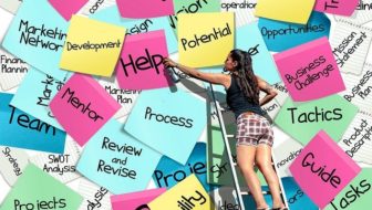 A woman climbing the ladder and pointing at help.