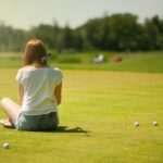 A woman sitting on the grass.