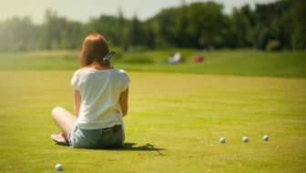 A woman sitting on the grass.
