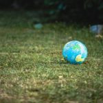 A small globe on the grass.