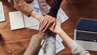 All people joining hands.