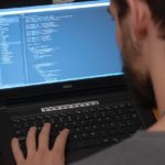 A man performing coding.