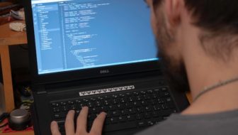 A man performing coding.