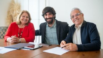 Three people talking about compensation insurance.