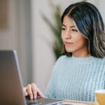 A woman working on the laptop.