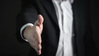 A man trying to shake hands.